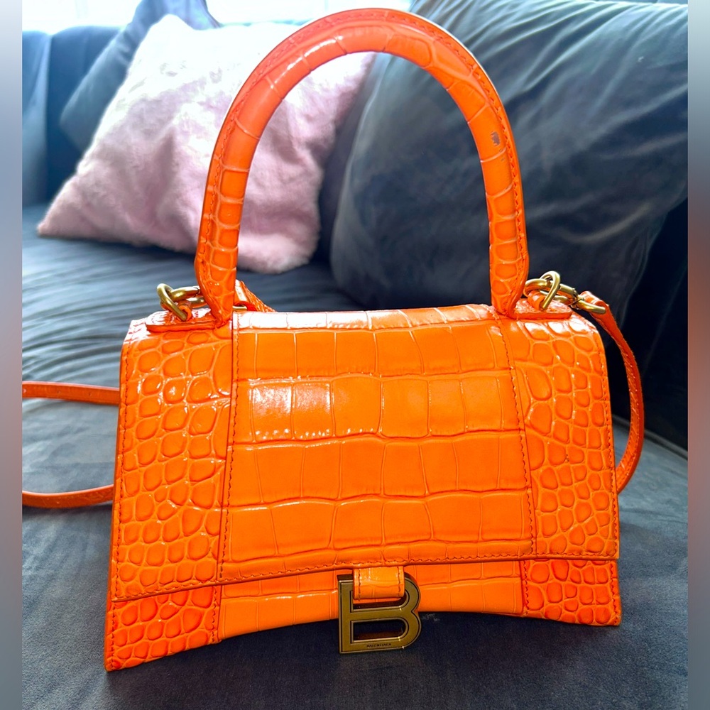 Balenciaga top-handle bag in crocodile-embossed
calfskin leather.